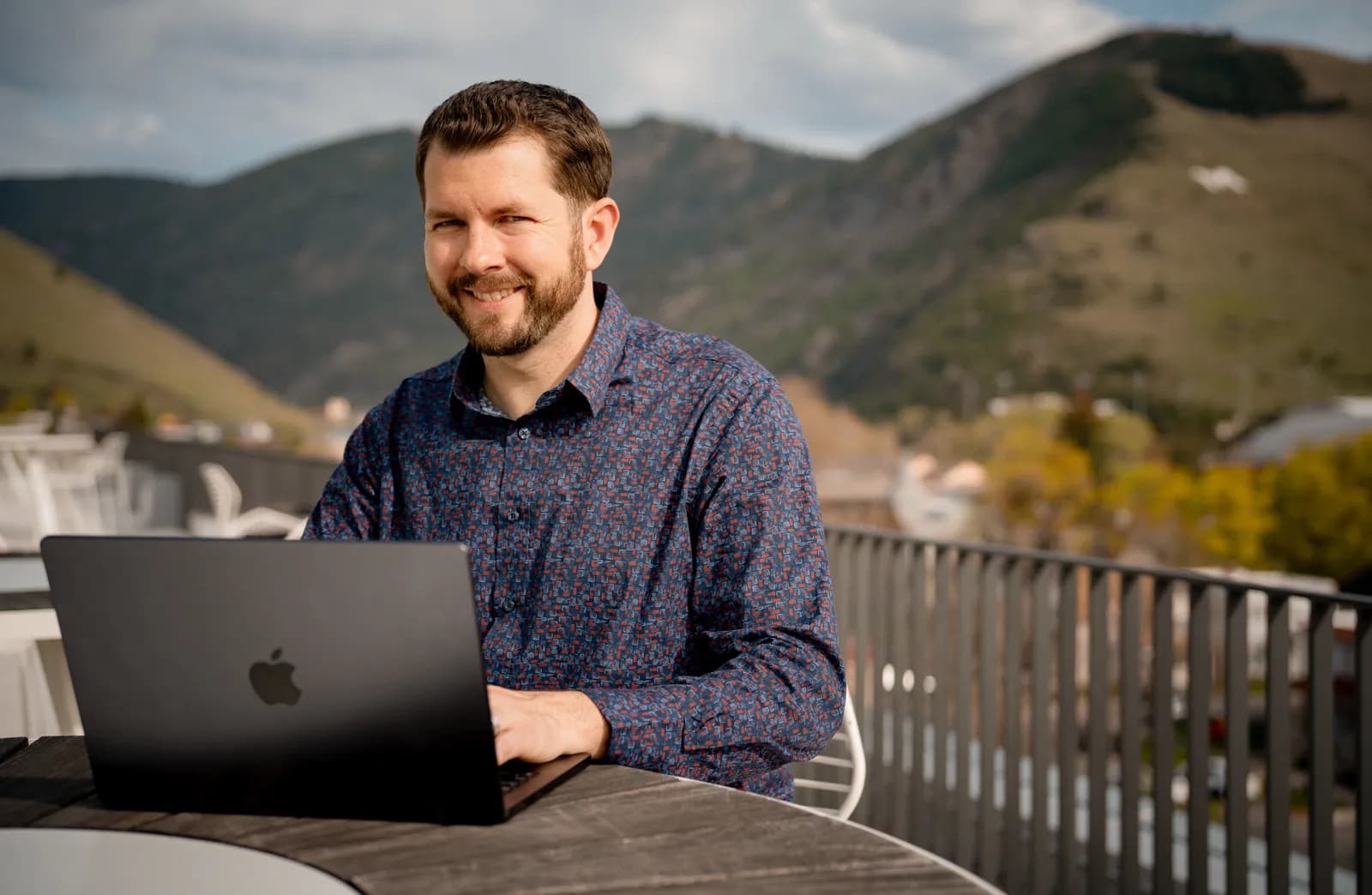 Chris DeWitt working on a rooftop in Missoula, Montana with Mt. Sentinel in the background